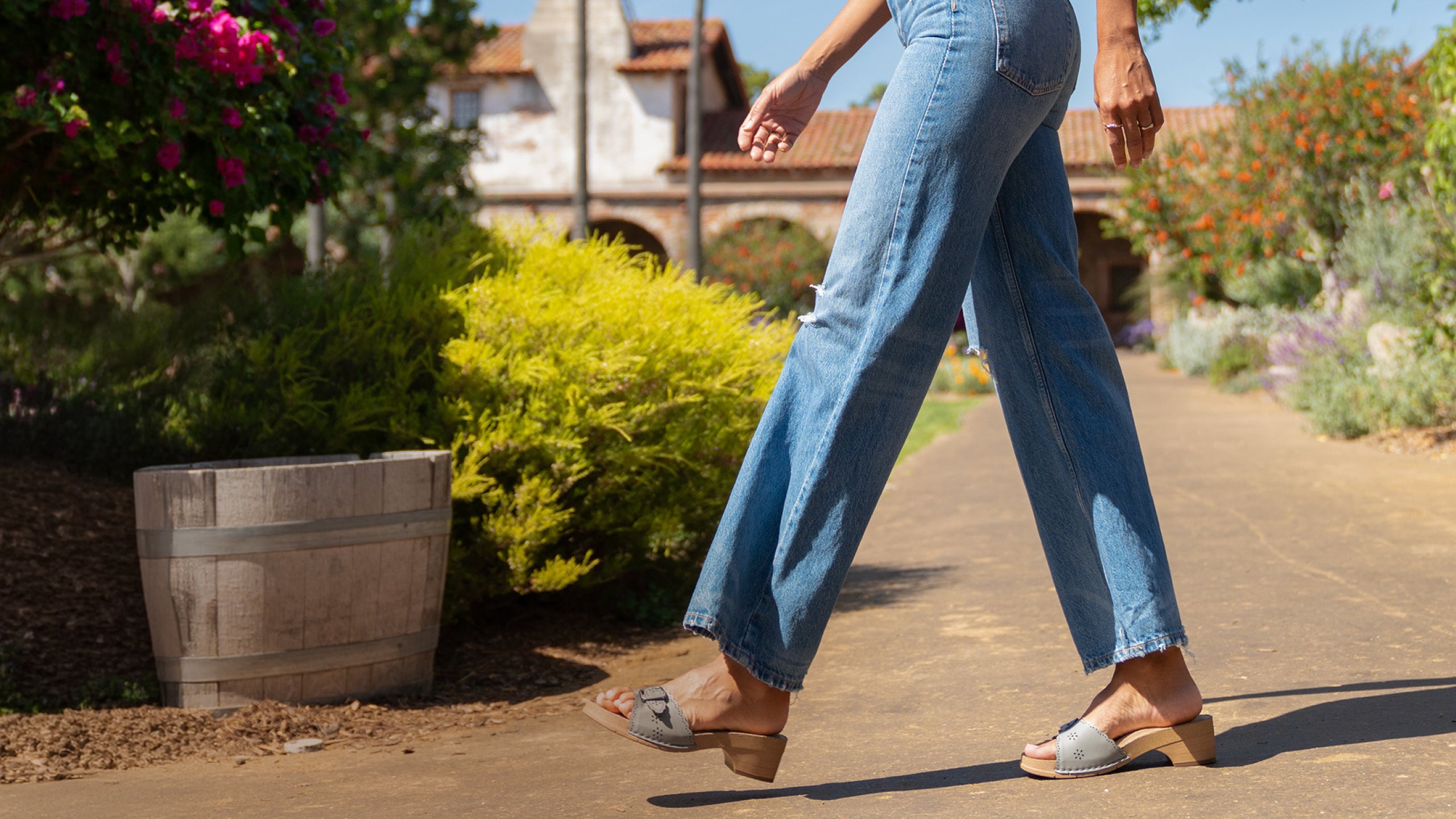 Model wearing Earth Shoes heeled clogs in grey
