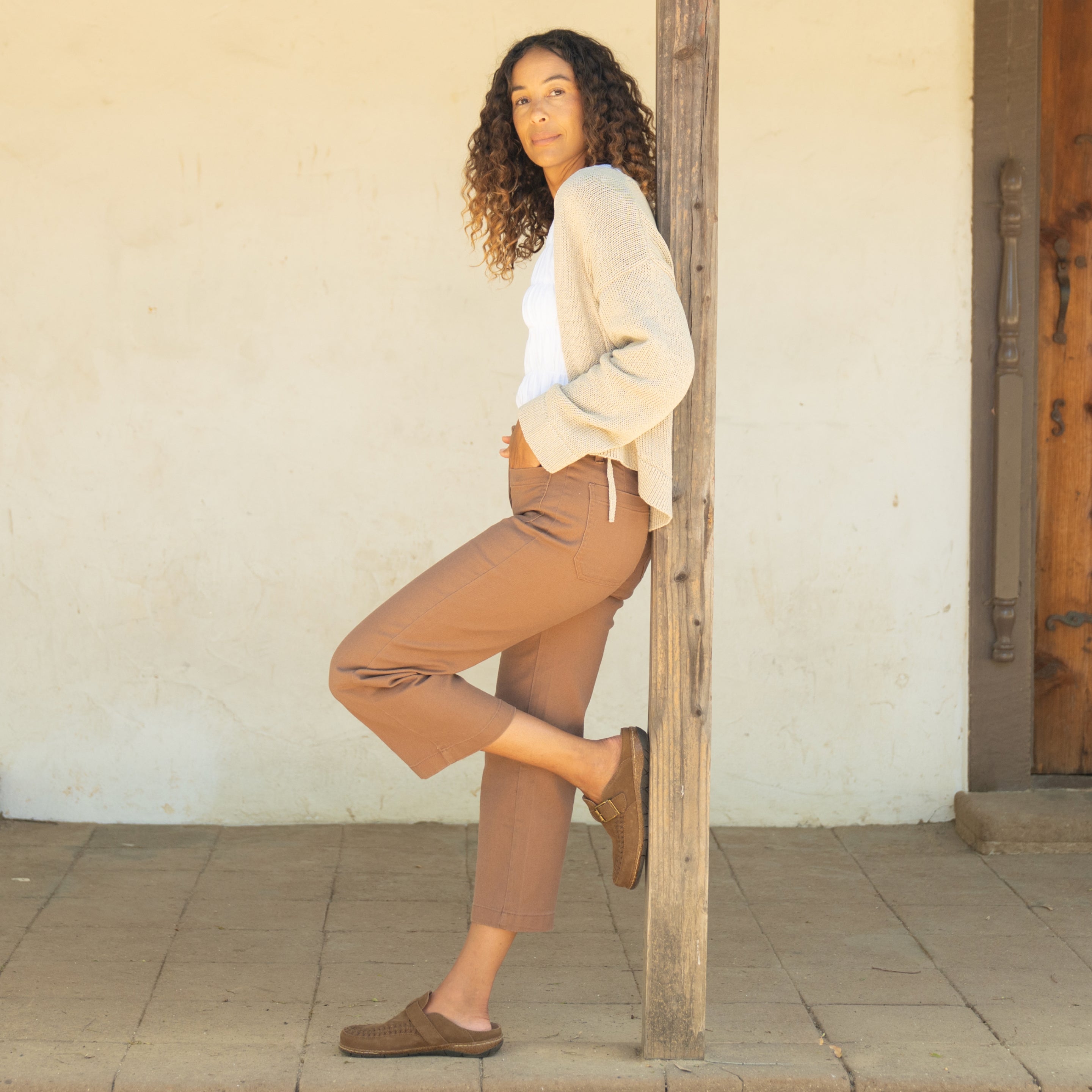 Model wearing Earth Shoes mule clogs in brown